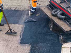 Imagen de Imagen de hombres esparciendo mezcla asfáltica